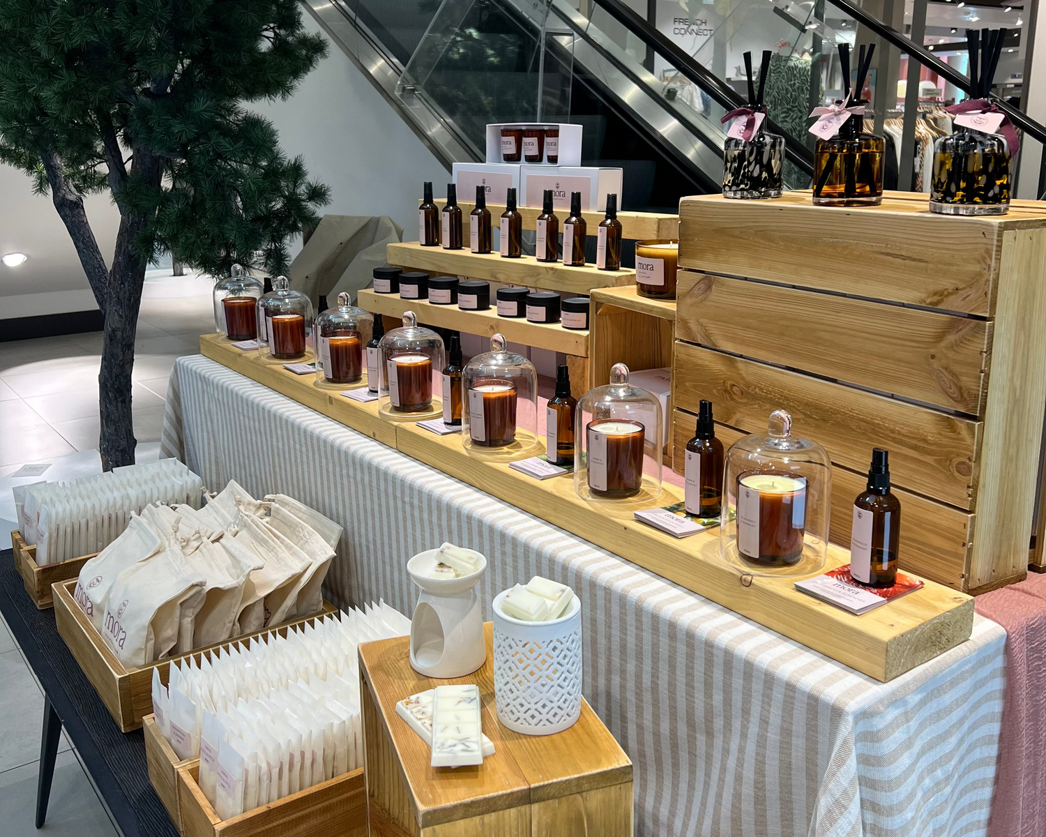 Cosmetic display setup with bottles, jars, and boxes in a store or showroom.