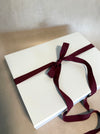 White gift box tied with Mora ribbon